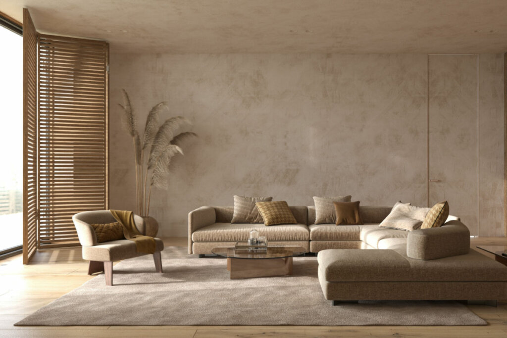 Sala de estar com sofás e paredes em tons de cinza e marrom