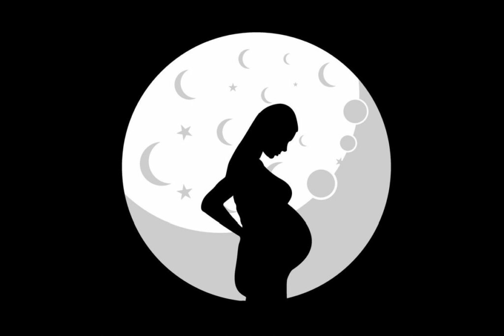Ilustração preta e branca de grávida com lua ao fundo