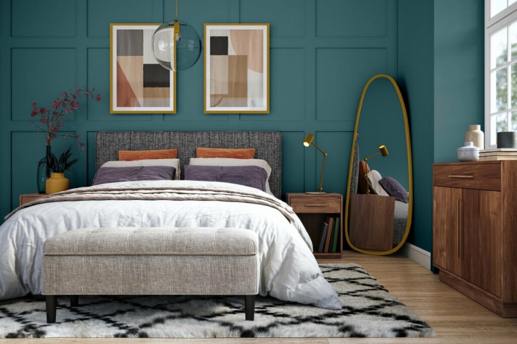 Quarto com parede verde-azulada, cabeceira cinza e cama branca 