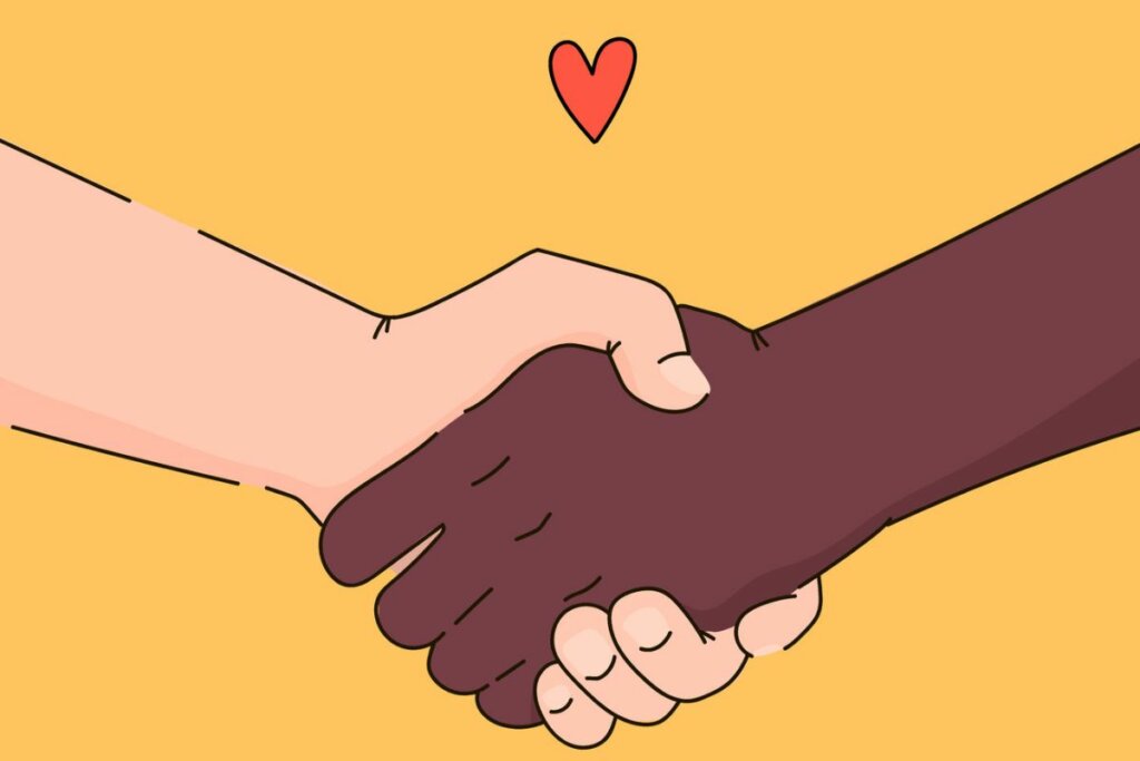 Ilustração de duas mãos de raças diferentes se unindo com um coração vermelho 