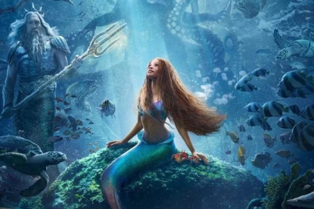 Imagem da Ariel sentada em pedra no fundo do mar