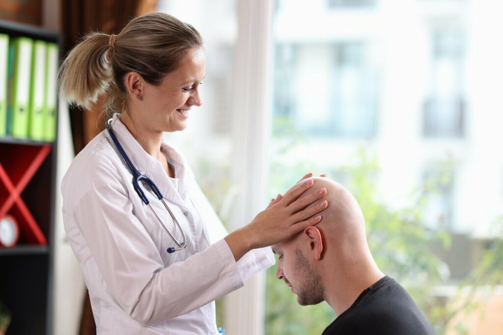 Médica examinando a cabeça de um homem 