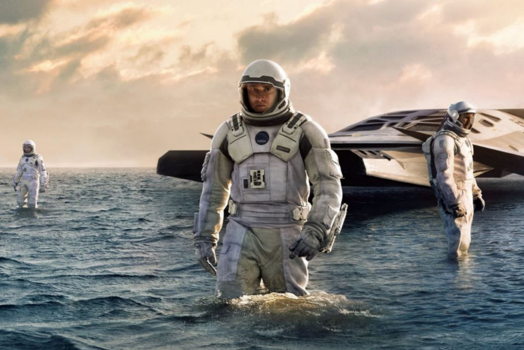 Personagens do filme "Interestelar" sob a água em novo planeta