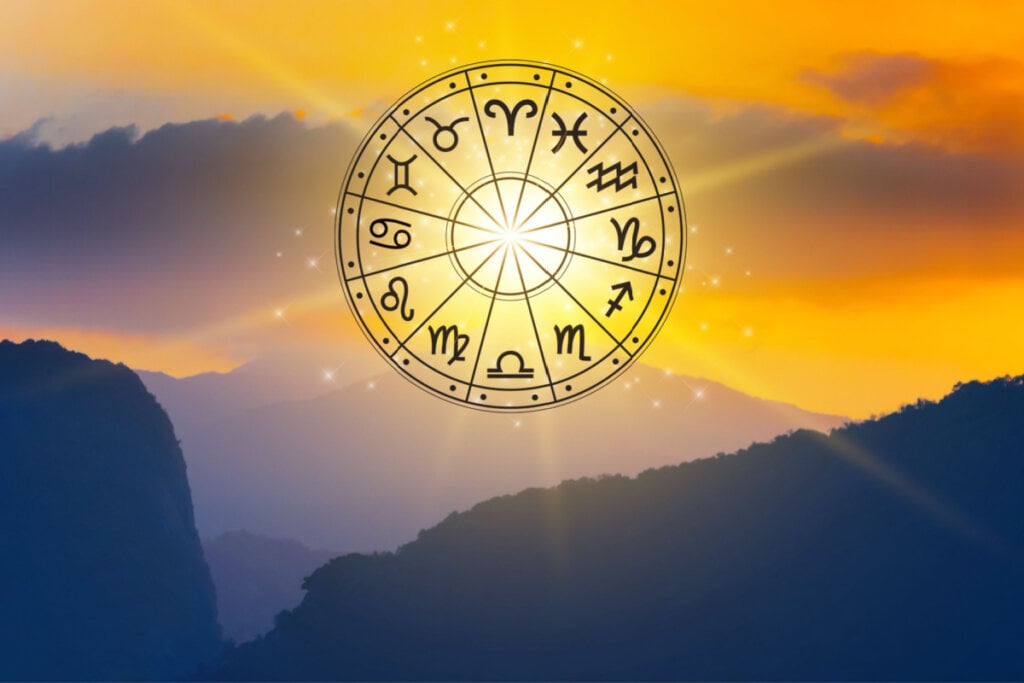 Mandala dos 12 signos entre montanhas e pôr do sol