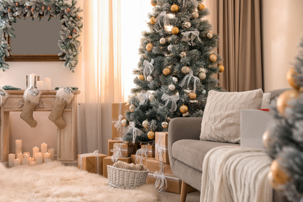 Árvore de Natal na sala de estar decorada com branco e dourado