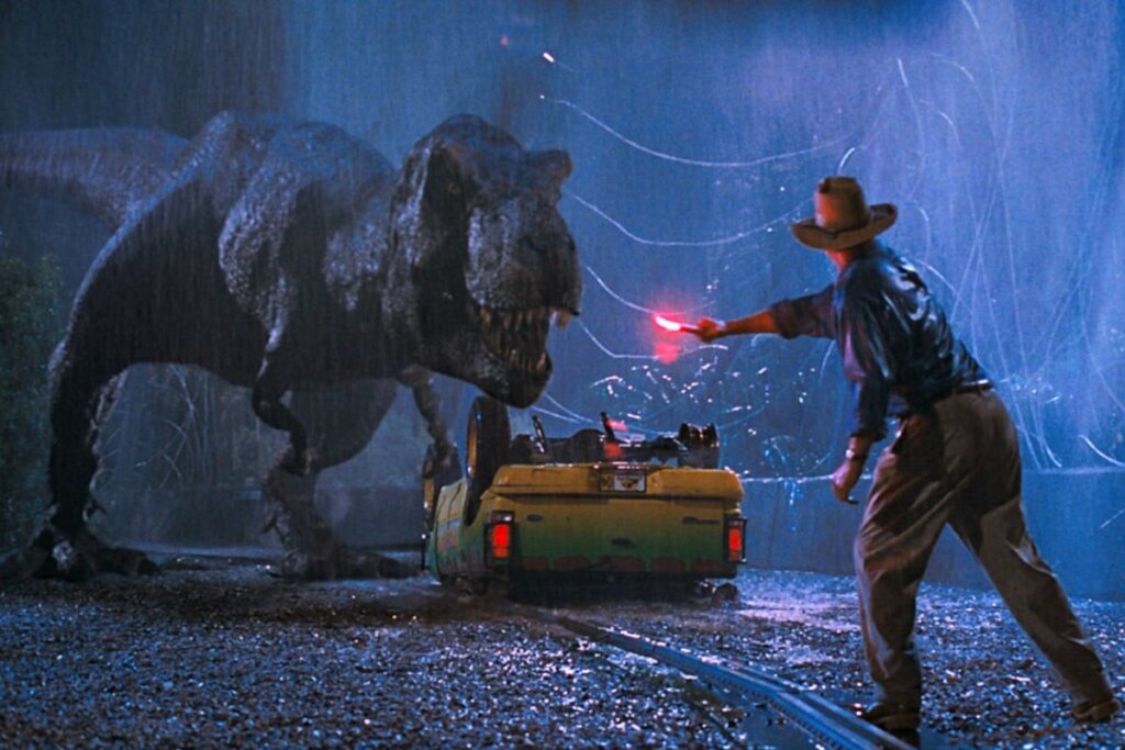 Cena do protagonistas do filme 'Jurassic Park' lutando com um dinossauro 
