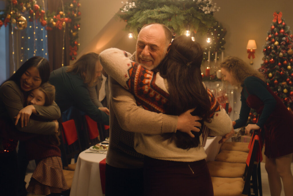 Família se abraçando, conversando e sorrindo durante o Natal