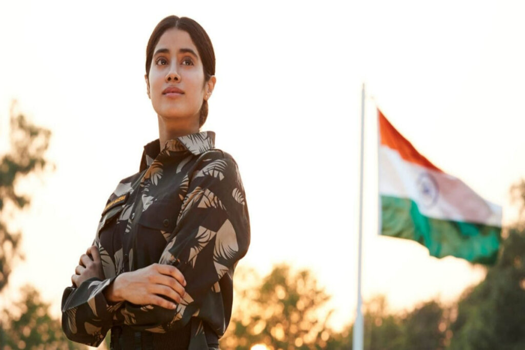 Mulher de braço cruzado em frente à bandeira hasteada da Índia. 