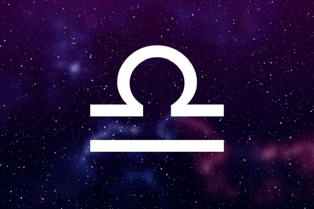 símbolo do signo de libra em fundo com galáxia roxo