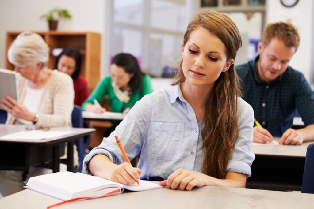 Jovem adulta escrevendo em caderno