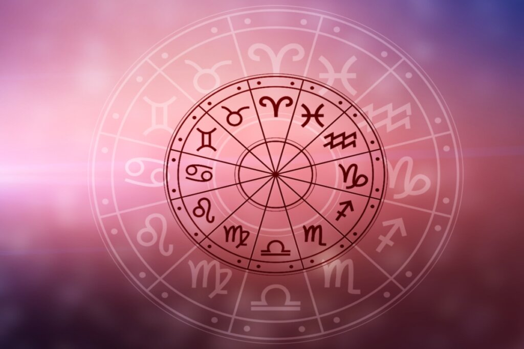 Círculo com os 12 signos do zodíaco e seus respectivos símbolos em fundo rosado