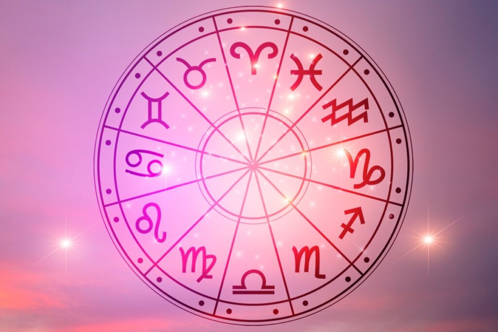 Círculo com os 12 signos do zodíaco em fundo rosado